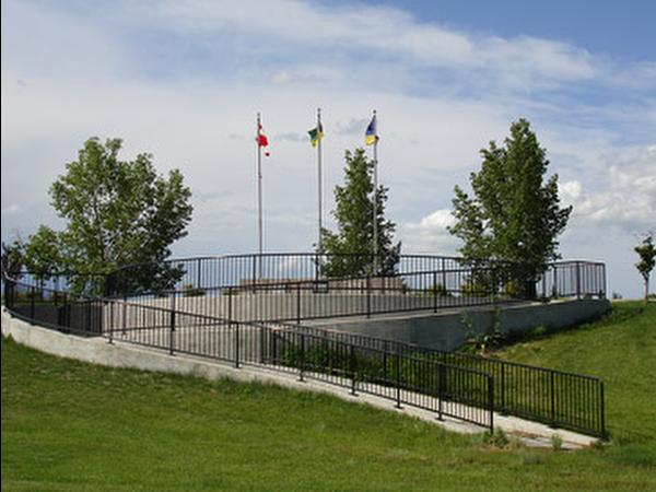 Dieppe memorial in Regina with flags green grass and blue sky
