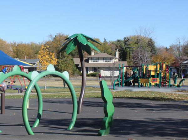 Albert Park playground and splash park with homes in the background blue sky 