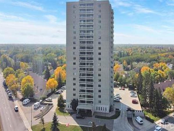 Large multi floor condo complex in Hillsdale are of Regina surrounded my homes trees Turing colour in fall and blue sky